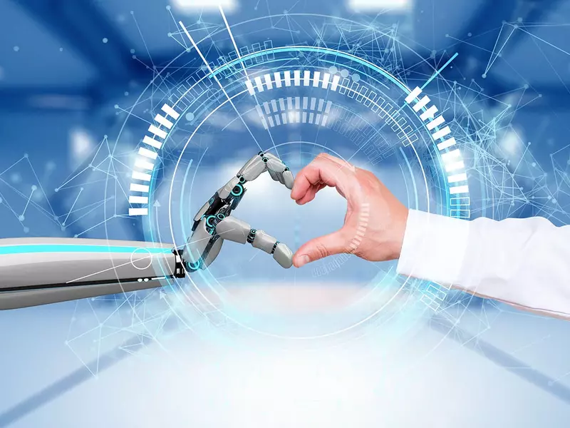 Ein Herz-Emoji aus einer biologisch menschlichen Hand und einer Roboterhand