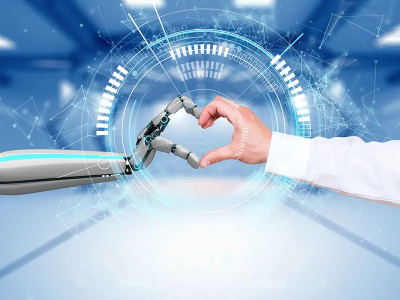 Ein Herz-Emoji aus einer biologisch menschlichen Hand und einer Roboterhand